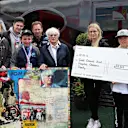 Keith Sutton (GBR) Sutton Images CEO and Mark Dickens (GBR) Artist with Bernie Ecclestone (GBR) CEO Formula One Group (FOM) who presents a cheque for Fifteen Thousand Pounds to Sinead O'Callaghan (IRL) Great Ormond Street Childrens Hospital raised by the sale of The World Champions in Art Collection Bernie Ecclestone art piece at Formula One World Championship, Rd10, British Grand Prix, Practice, Silverstone, England, Friday 8 July 2016. © Sutton Images