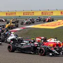Jenson Button (GBR) McLaren MP4-31 and Sebastian Vettel (GER) Ferrari SF16-H at the start of the race at Formula One World Championship, Rd3, Chinese Grand Prix, Race, Shanghai, China, Sunday 17 April 2016. © Sutton Motorsport Images
