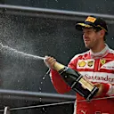 Sebastian Vettel (GER) Ferrari celebrates with the champagne on the podium at Formula One World Championship, Rd3, Chinese Grand Prix, Race, Shanghai, China, Sunday 17 April 2016. © Sutton Motorsport Images