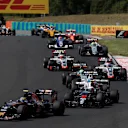 Carlos Sainz (ESP) Scuderia Toro Rosso STR11 and Jenson Button (GBR) McLaren MP4-31 at the start of the race at Formula One World Championship, Rd11, Hungarian Grand Prix, Race, Hungaroring, Hungary, Sunday 24 July 2016. © Sutton Images