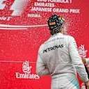 Race winner Nico Rosberg (GER) Mercedes AMG F1 and Lewis Hamilton (GBR) Mercedes AMG F1 celebrate on the podium with the champagne at Formula One World Championship, Rd17, Japanese Grand Prix, Race, Suzuka, Japan, Sunday 9 October 2016. © Sutton Images