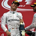 Race winner Nico Rosberg (GER) Mercedes AMG F1 and Lewis Hamilton (GBR) Mercedes AMG F1 celebrate on the podium with the champagne at Formula One World Championship, Rd17, Japanese Grand Prix, Race, Suzuka, Japan, Sunday 9 October 2016. © Sutton Images