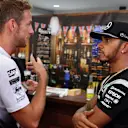 Jenson Button (GBR) McLaren celebrates his 300th Grand Prix with Lewis Hamilton (GBR) Mercedes AMG F1 at Formula One World Championship, Rd16, Malaysian Grand Prix, Practice, Sepang, Malaysia, Friday 30 September 2016. © Sutton Images