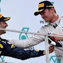 Race winner Daniel Ricciardo (AUS) Red Bull Racing and Nico Rosberg (GER) Mercedes AMG F1 celebrate on the podium at Formula One World Championship, Rd16, Malaysian Grand Prix, Race,  Sepang, Malaysia, Sunday 2 October 2016. © Sutton Images