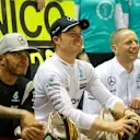 Lewis Hamilton (GBR) Mercedes AMG F1 and Nico Rosberg (GER) Mercedes AMG F1 celebrate with the team and the trophies at Formula One World Championship, Rd15, Singapore Grand Prix, Race, Marina Bay Street Circuit, Singapore, Sunday 18 September 2016. © Sutton Images