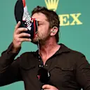 Gerard Butler (GBR) Actor drinks from the boot of Daniel Ricciardo (AUS) Red Bull Racing on the podium at Formula One World Championship, Rd18, United States Grand Prix, Race, Circuit of the Americas, Austin, Texas, USA, Sunday 23 October 2016. © Sutton Images