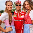 Sebastian Vettel (GER) Ferrari and girls at Formula One World Championship, Rd9, Austrian Grand Prix, Qualifying, Spielberg, Austria, Saturday 8 July 2017. © Sutton Images