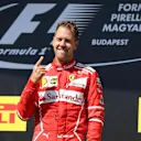 Race winner Sebastian Vettel (GER) Ferrari celebrates on the podium at Formula One World Championship, Rd11, Hungarian Grand Prix, Race, Hungaroring, Hungary, Sunday 30 July 2017. © Sutton Images