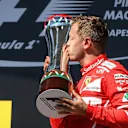 race winner Sebastian Vettel (GER) Ferrari celebrates on the podium and kisses the trophy at Formula One World Championship, Rd11, Hungarian Grand Prix, Race, Hungaroring, Hungary, Sunday 30 July 2017. © Sutton Images