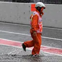 Marshal and flooded pit lane at Formula One World Championship, Rd16, Japanese Grand Prix, Practice, Suzuka, Japan, Friday 6 October 2017. © Mark Sutton/Sutton Images