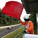 Marshal waves the red flag in FP3 at Formula One World Championship, Rd16, Japanese Grand Prix, Qualifying, Suzuka, Japan, Saturday 7 October 2017. © Kym Illman/Sutton Images