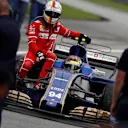 Pascal Wehrlein (GER) Sauber C36 gives Sebastian Vettel (GER) Ferrari a lift at Formula One World Championship, Rd15, Malaysian Grand Prix, Race, Sepang, Malaysia, Sunday 1 October 2017. © Glenn Dunbar/Sutton Images