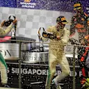 Daniel Ricciardo (AUS) Red Bull Racing, Lewis Hamilton (GBR) Mercedes AMG F1 and Valtteri Bottas (FIN) Mercedes AMG F1 celebrate on the podium with the champagne at Formula One World Championship, Rd14, Singapore Grand Prix, Race, Marina Bay Street Circuit, Singapore, Sunday 17 September 2017. © Sutton Images