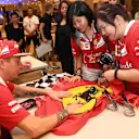 Kimi Raikkonen (FIN) Ferrari signs autographs for the fans at Formula One World Championship, Rd14, Singapore Grand Prix, Preparations, Marina Bay Street Circuit, Singapore, Thursday 14 September 2017. © Sutton Images