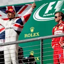 Race winner Lewis Hamilton (GBR) Mercedes AMG F1 and Kimi Raikkonen (FIN) Ferrari celebrate on the podium with the Union Jack Flag at Formula One World Championship, Rd17, United States Grand Prix, Race, Circuit of the Americas, Austin, Texas, USA, Sunday