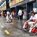 Alfa Romeo Sauber F1 Team mechanics dry the pit box at Formula One World Championship, Rd1, Australian Grand Prix, Qualifying, Melbourne, Australia, Saturday 24 March 2018. © Mark Sutton/Sutton Images