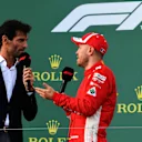 Race winner Sebastian Vettel (GER) Ferrari talks with Mark Webber (AUS) on the podium at Formula One World Championship, Rd1, Australian Grand Prix, Race, Melbourne, Australia, Sunday 25 March 2018. © Mark Sutton/Sutton Images