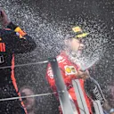 Max Verstappen (NED) Red Bull Racing and Sebastian Vettel (GER) Ferrari celebrate on the podium with the champagne at Formula One World Championship, Rd9, Austrian Grand Prix, Race, Spielberg, Austria, Sunday 1 July 2018. © Jerry Andre/Sutton Images