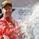 Sebastian Vettel (GER) Ferrari celebrates on the podium with the champagne at Formula One World Championship, Rd9, Austrian Grand Prix, Race, Spielberg, Austria, Sunday 1 July 2018. © Mark Sutton/Sutton Images