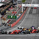 Lewis Hamilton (GBR) Mercedes-AMG F1 W09 EQ Power+, Valtteri Bottas (FIN) Mercedes-AMG F1 W09 EQ Power+ and Kimi Raikkonen (FIN) Ferrari SF-71H battle at the start of the race at Formula One World Championship, Rd9, Austrian Grand Prix, Race, Spielberg, Austria, Sunday 1 July 2018. © Mark Sutton/Sutton Images