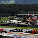 Lewis Hamilton (GBR) Mercedes-AMG F1 and Kimi Raikkonen (FIN) Ferrari SF-71H battle on lap one at Formula One World Championship, Rd9, Austrian Grand Prix, Race, Spielberg, Austria, Sunday 1 July 2018. © Manuel Goria/Sutton Images