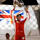 Race winner Sebastian Vettel (GER) Ferrari celebrates on the podium with the trophy at Formula One World Championship, Rd2, Bahrain Grand Prix, Race, Bahrain International Circuit, Sakhir, Bahrain, Sunday 8 April 2018. © Manuel Goria/Sutton Images