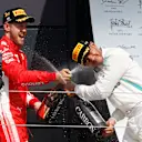Sebastian Vettel (GER) Ferrari and Lewis Hamilton (GBR) Mercedes-AMG F1 celebrate on the podium with the champagne at Formula One World Championship, Rd10, British Grand Prix, Race, Silverstone, England, Sunday 8 July 2018. © Manuel Goria/Sutton Images