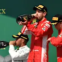 Lewis Hamilton (GBR) Mercedes-AMG F1, Sebastian Vettel (GER) Ferrari and Kimi Raikkonen (FIN) Ferrari celebrates on the podium with the champagne at Formula One World Championship, Rd10, British Grand Prix, Race, Silverstone, England, Sunday 8 July 2018. © Mark Sutton/Sutton Images