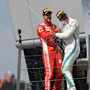 Sebastian Vettel (GER) Ferrari and Lewis Hamilton (GBR) Mercedes-AMG F1 celebrates on the podium with the champagne at Formula One World Championship, Rd10, British Grand Prix, Race, Silverstone, England, Sunday 8 July 2018. © Mark Sutton/Sutton Images
