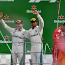 Race winner Lewis Hamilton, Mercedes AMG F1 celebrates on the podium with Valtteri Bottas, Mercedes AMG F1 as Kimi Raikkonen, Ferrari signs a flag at Formula One World Championship, Rd14, Italian Grand Prix, Race, Monza, Italy, Sunday 2 September 2018. © Mark Sutton/Sutton Images