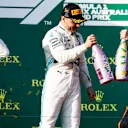 MELBOURNE GRAND PRIX CIRCUIT, AUSTRALIA - MARCH 17: Lewis Hamilton, Mercedes AMG F1, 2nd position, Valtteri Bottas, Mercedes AMG F1, 1st position, and Max Verstappen, Red Bull Racing, 3rd position, celebrate with Champagne on the podium during the Australian GP at Melbourne Grand Prix Circuit on March 17, 2019 in Melbourne Grand Prix Circuit, Australia. (Photo by Glenn Dunbar / LAT Images)