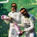 MELBOURNE GRAND PRIX CIRCUIT, AUSTRALIA - MARCH 17: Lewis Hamilton, Mercedes AMG F1, 2nd position, sprays Valtteri Bottas, Mercedes AMG F1, 1st position, with Champagne on the podium during the Australian GP at Melbourne Grand Prix Circuit on March 17, 2019 in Melbourne Grand Prix Circuit, Australia. (Photo by Mark Sutton / Sutton Images)