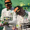 MELBOURNE GRAND PRIX CIRCUIT, AUSTRALIA - MARCH 17: Lewis Hamilton, Mercedes AMG F1, 2nd position, sprays Valtteri Bottas, Mercedes AMG F1, 1st position, with Champagne on the podium during the Australian GP at Melbourne Grand Prix Circuit on March 17, 2019 in Melbourne Grand Prix Circuit, Australia. (Photo by Mark Sutton / Sutton Images)