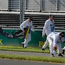 MELBOURNE GRAND PRIX CIRCUIT, AUSTRALIA - MARCH 17: Marshals remove the front wing and debris belonging to the car of Daniel Ricciardo, Renault, from the circuit during the Australian GP at Melbourne Grand Prix Circuit on March 17, 2019 in Melbourne Grand Prix Circuit, Australia. (Photo by Steven Tee / LAT Images)