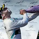 MELBOURNE GRAND PRIX CIRCUIT, AUSTRALIA - MARCH 17: Valtteri Bottas, Mercedes AMG F1, 1st position, sprays the victory Champagne into his face during the Australian GP at Melbourne Grand Prix Circuit on March 17, 2019 in Melbourne Grand Prix Circuit, Australia. (Photo by LAT Images)