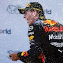 RED BULL RING, AUSTRIA - JUNE 30: Max Verstappen, Red Bull Racing, 1st position, sprays Champagne on the podium during the Austrian GP at Red Bull Ring on June 30, 2019 in Red Bull Ring, Austria. (Photo by Glenn Dunbar / LAT Images)