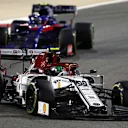 BAHRAIN INTERNATIONAL CIRCUIT, BAHRAIN - MARCH 31: Antonio Giovinazzi, Alfa Romeo Racing C38, leads Alexander Albon, Toro Rosso STR14 during the Bahrain GP at Bahrain International Circuit on March 31, 2019 in Bahrain International Circuit, Bahrain. (Photo by Glenn Dunbar / LAT Images)