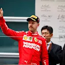 SHANGHAI INTERNATIONAL CIRCUIT, CHINA - APRIL 14: Sebastian Vettel, Ferrari celebrates on the podium during the Chinese GP at Shanghai International Circuit on April 14, 2019 in Shanghai International Circuit, China. (Photo by Glenn Dunbar / LAT Images)