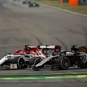 SHANGHAI INTERNATIONAL CIRCUIT, CHINA - APRIL 14: Kimi Raikkonen, Alfa Romeo Racing C38, battles with Romain Grosjean, Haas VF-19 during the Chinese GP at Shanghai International Circuit on April 14, 2019 in Shanghai International Circuit, China. (Photo by Andy Hone / LAT Images)