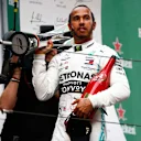 SHANGHAI INTERNATIONAL CIRCUIT, CHINA - APRIL 14: Lewis Hamilton, Mercedes AMG F1, 1st position, with his trophy and Champagne during the Chinese GP at Shanghai International Circuit on April 14, 2019 in Shanghai International Circuit, China. (Photo by Andy Hone / LAT Images)
