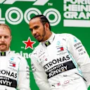SHANGHAI INTERNATIONAL CIRCUIT, CHINA - APRIL 14: Valtteri Bottas, Mercedes AMG F1, 2nd position, and Lewis Hamilton, Mercedes AMG F1, 1st position, on the podium during the Chinese GP at Shanghai International Circuit on April 14, 2019 in Shanghai International Circuit, China. (Photo by Glenn Dunbar / LAT Images)