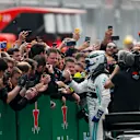 SHANGHAI INTERNATIONAL CIRCUIT, CHINA - APRIL 14: Valtteri Bottas, Mercedes AMG F1, 2nd position, celebrates with his team in Parc Ferme during the Chinese GP at Shanghai International Circuit on April 14, 2019 in Shanghai International Circuit, China. (Photo by Zak Mauger / LAT Images)