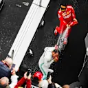 SHANGHAI INTERNATIONAL CIRCUIT, CHINA - APRIL 14: Lewis Hamilton, Mercedes AMG F1, 1st position, and Sebastian Vettel, Ferrari, 3rd position, spray Champagne on the podium during the Chinese GP at Shanghai International Circuit on April 14, 2019 in Shanghai International Circuit, China. (Photo by Steven Tee / LAT Images)