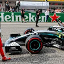 SHANGHAI INTERNATIONAL CIRCUIT, CHINA - APRIL 13: Sebastian Vettel, Ferrari, and pole man Valtteri Bottas, Mercedes AMG W10, on the grid after Qualifying during the Chinese GP at Shanghai International Circuit on April 13, 2019 in Shanghai International Circuit, China. (Photo by Steven Tee / LAT Images)