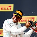 CIRCUIT PAUL RICARD, FRANCE - JUNE 23: Lewis Hamilton, Mercedes AMG F1, 1st position, and Charles Leclerc, Ferrari, 3rd position, spray Champagne on the podium during the French GP at Circuit Paul Ricard on June 23, 2019 in Circuit Paul Ricard, France. (Photo by Joe Portlock / LAT Images)