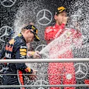 HOCKENHEIMRING, GERMANY - JULY 28: Race winner Max Verstappen, Red Bull Racing and Sebastian Vettel, Ferrari celebrates on the podium with the champagne during the German GP at Hockenheimring on July 28, 2019 in Hockenheimring, Germany. (Photo by Sam Bloxham / LAT Images)