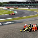 SILVERSTONE, UNITED KINGDOM - JULY 12: Charles Leclerc, Ferrari SF90 passing the car of Daniel Ricciardo, Renault R.S.19 being pushed by marshals after stopping on track during the British GP at Silverstone on July 12, 2019 in Silverstone, United Kingdom. (Photo by Glenn Dunbar / LAT Images)