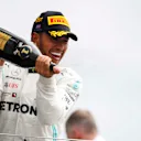 SILVERSTONE, UNITED KINGDOM - JULY 14: Lewis Hamilton, Mercedes AMG F1, 1st position, sprays Champagne on the podium during the British GP at Silverstone on July 14, 2019 in Silverstone, United Kingdom. (Photo by Joe Portlock / LAT Images)
