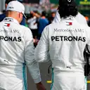 HUNGARORING, HUNGARY - AUGUST 03: Valtteri Bottas, Mercedes AMG F1, and Lewis Hamilton, Mercedes AMG F1, on the grid after Qualifying during the Hungarian GP at Hungaroring on August 03, 2019 in Hungaroring, Hungary. (Photo by Steven Tee / LAT Images)
