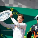 HUNGARORING, HUNGARY - AUGUST 04: Matt Deane, Chief Mechanic, Mercedes AMG, receives the Constructors trophy for Mercedes alongside Max Verstappen, Red Bull Racing, 2nd position during the Hungarian GP at Hungaroring on August 04, 2019 in Hungaroring, Hungary. (Photo by Joe Portlock / LAT Images)